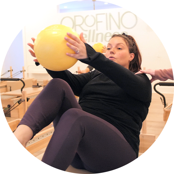 woman holding yellow exercise ball