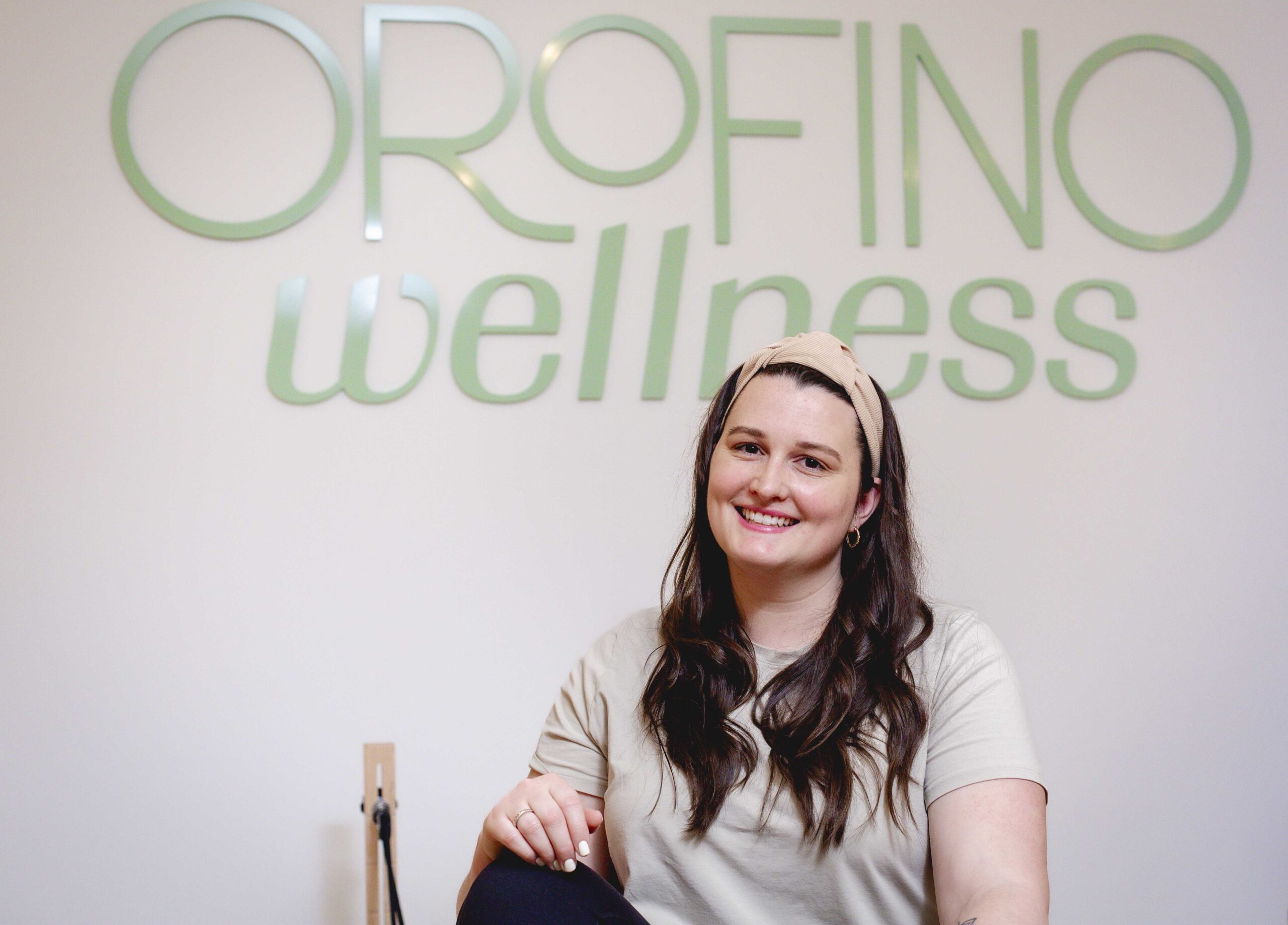 Melanie Meyer in front of the Orofino Wellness sign