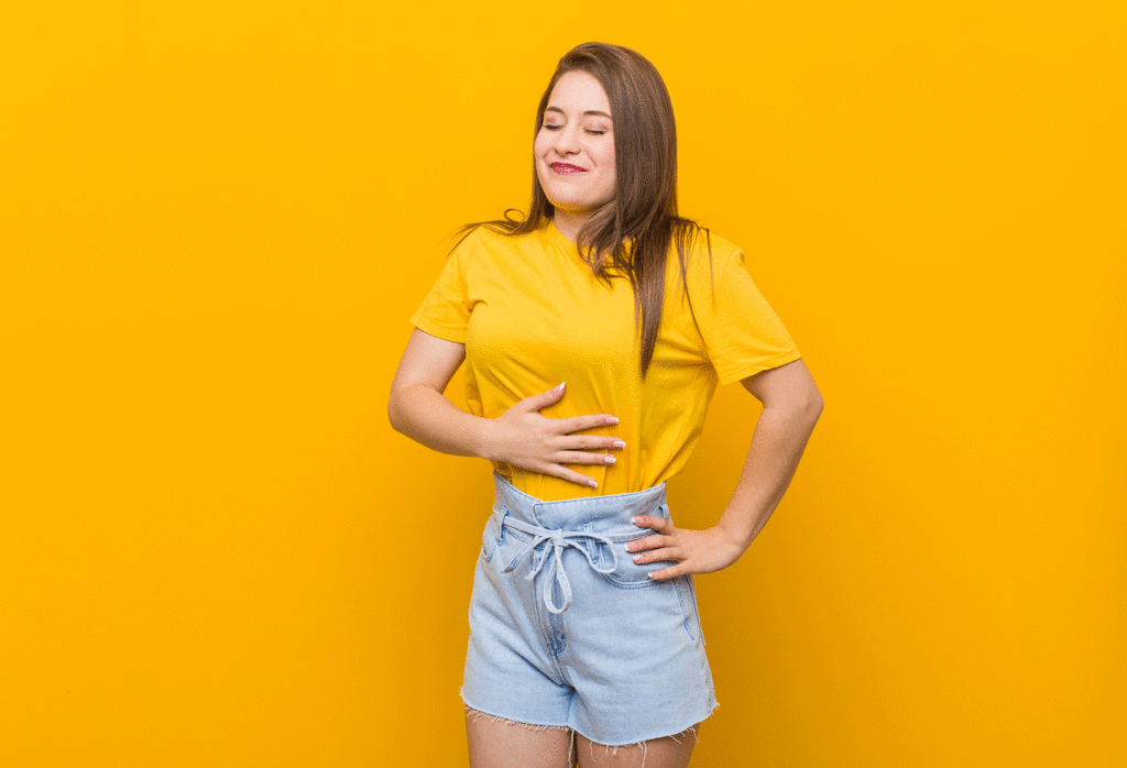 Woman in yellow shirt looking satisfied.