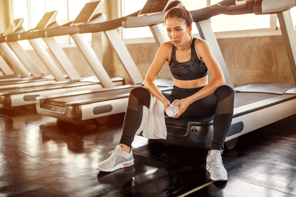 Asian woman sitting tied on a treadmill