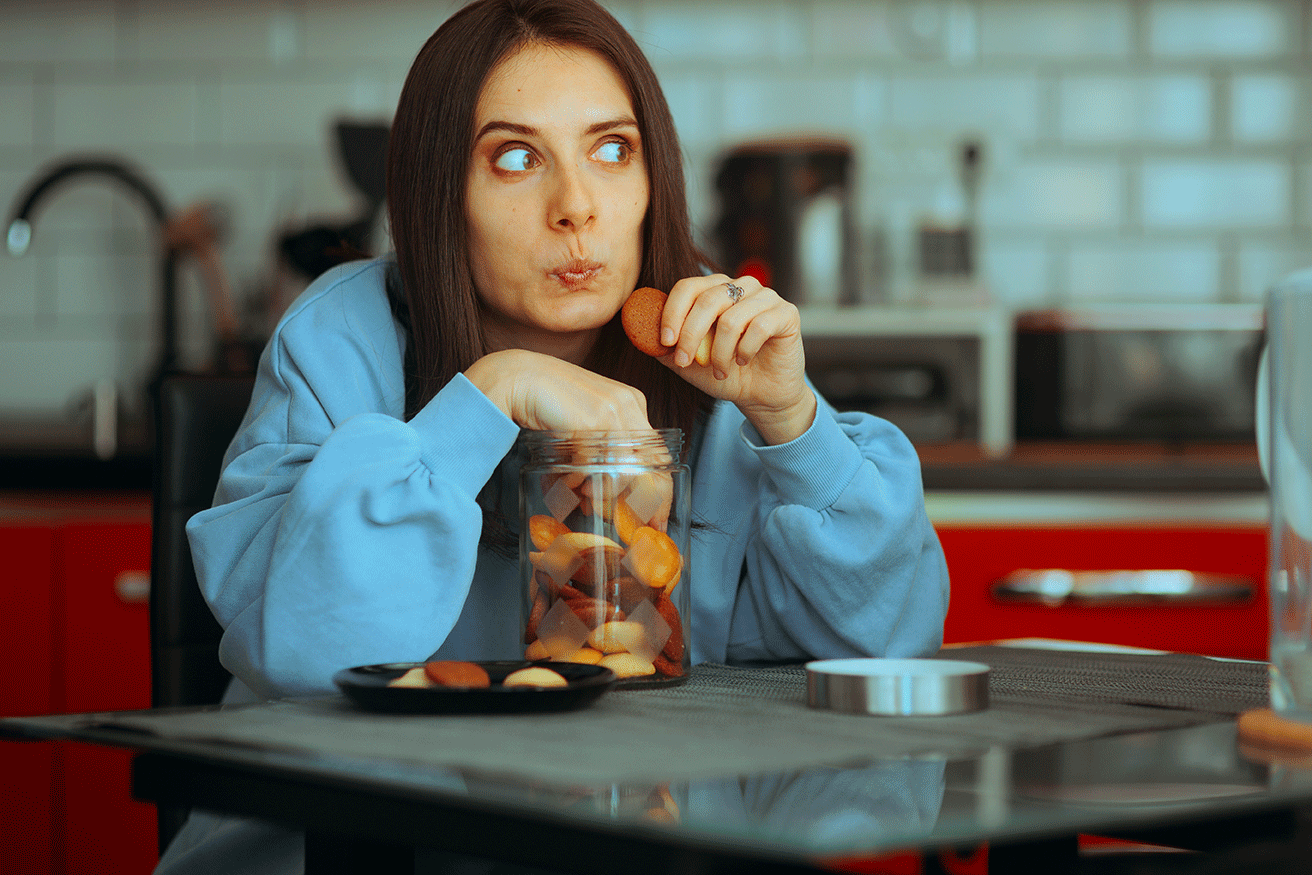 Woman sneakily eating cookies